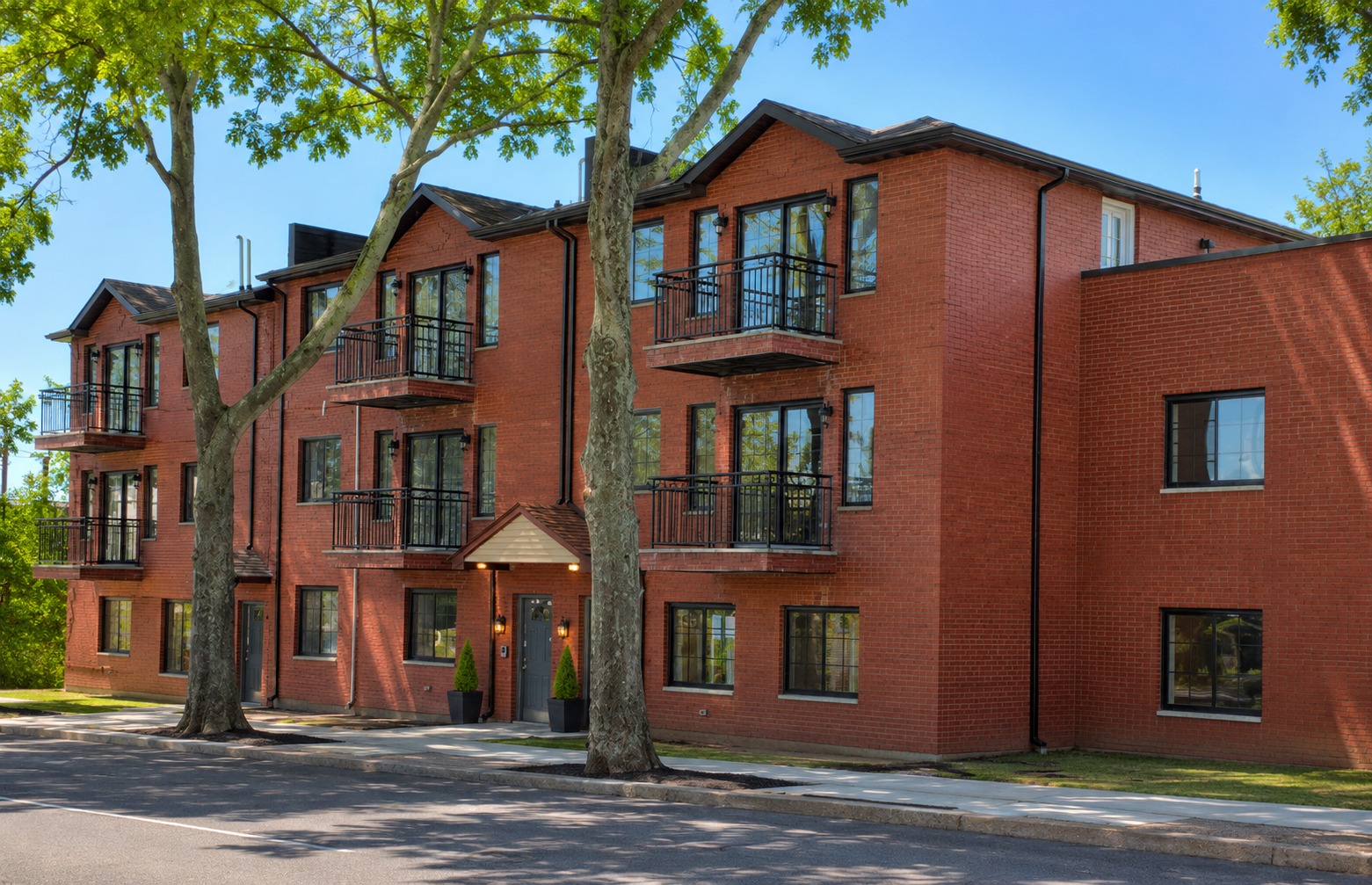 Red brick three-story multifamily building at Okwin Capital's East Elmhurst, Queens NYC property