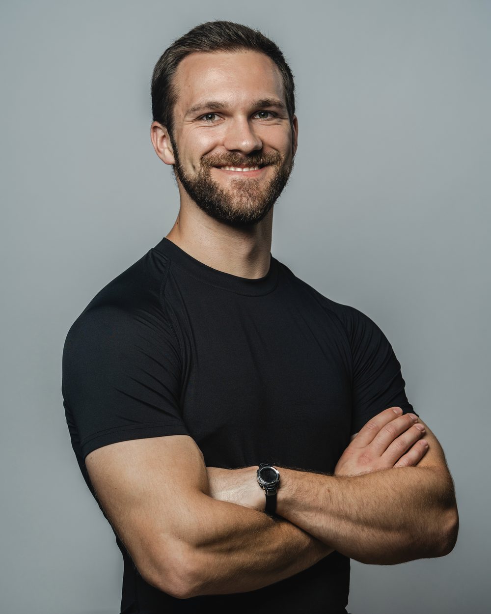 Javen Morris, founder of Fitadel Fitness Games and creator of Gritspire, smiling with arms crossed