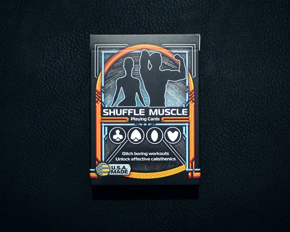 Shuffle Muscle playing card deck box on dark leather