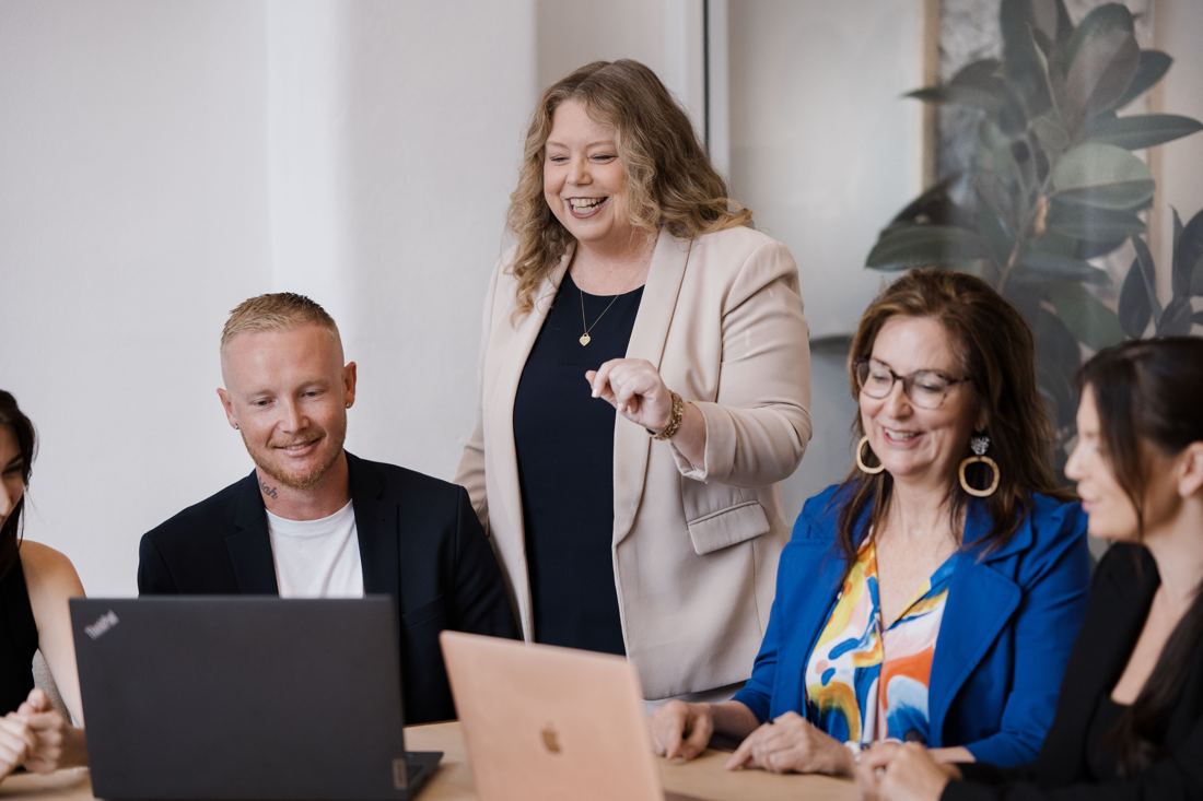 Tracey Leak working with a group of business owners around a table
