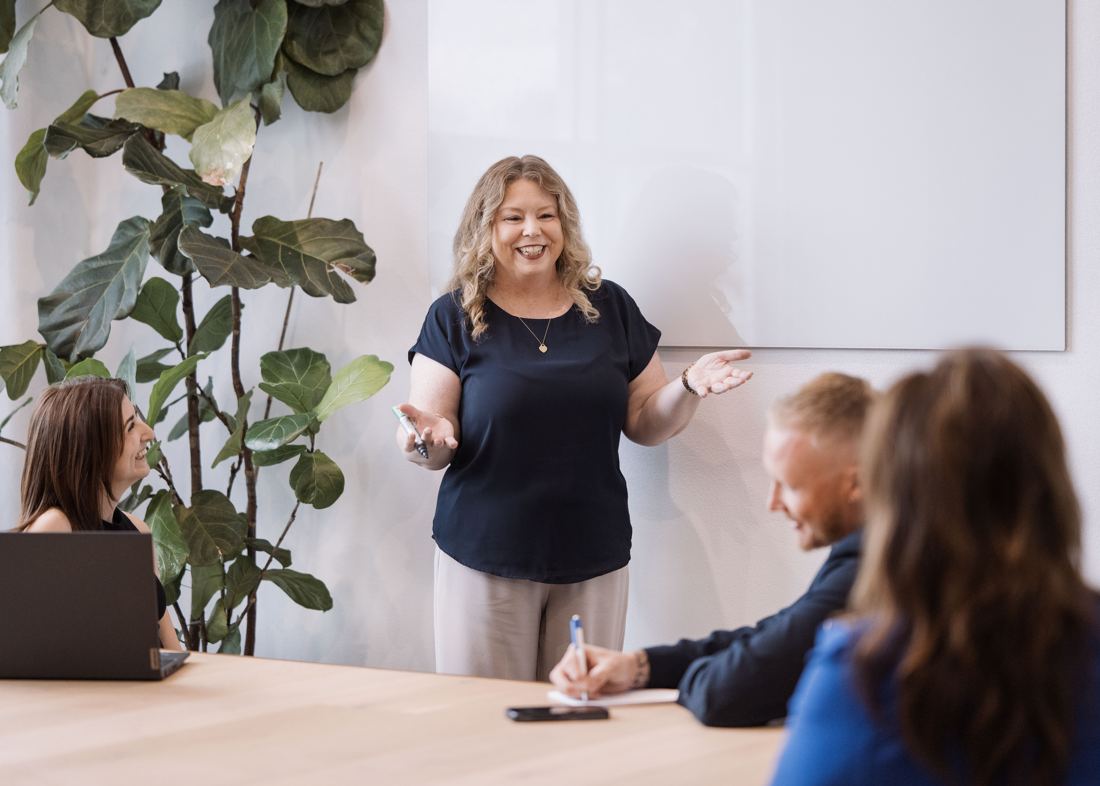 Tracey Leak presenting to a group at a whiteboard