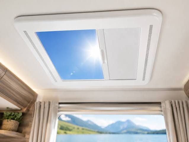 Interior view of a white-framed skylight with blue sky