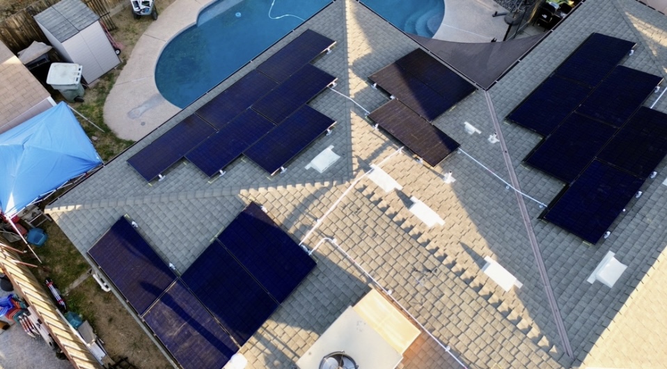 “Clean, well-maintained residential roof with intact shingles and clear sky in the background, showing no visible signs of damage.”