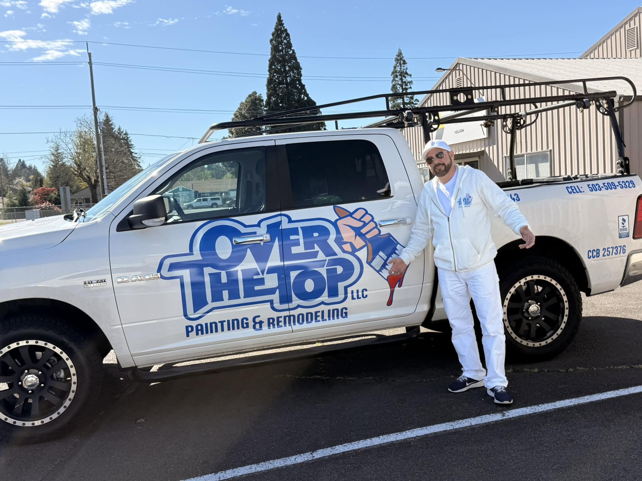 Neil Young, founder and owner of Over The Top Painting & Remodeling, standing in front of the branded company truck in Salem, OR