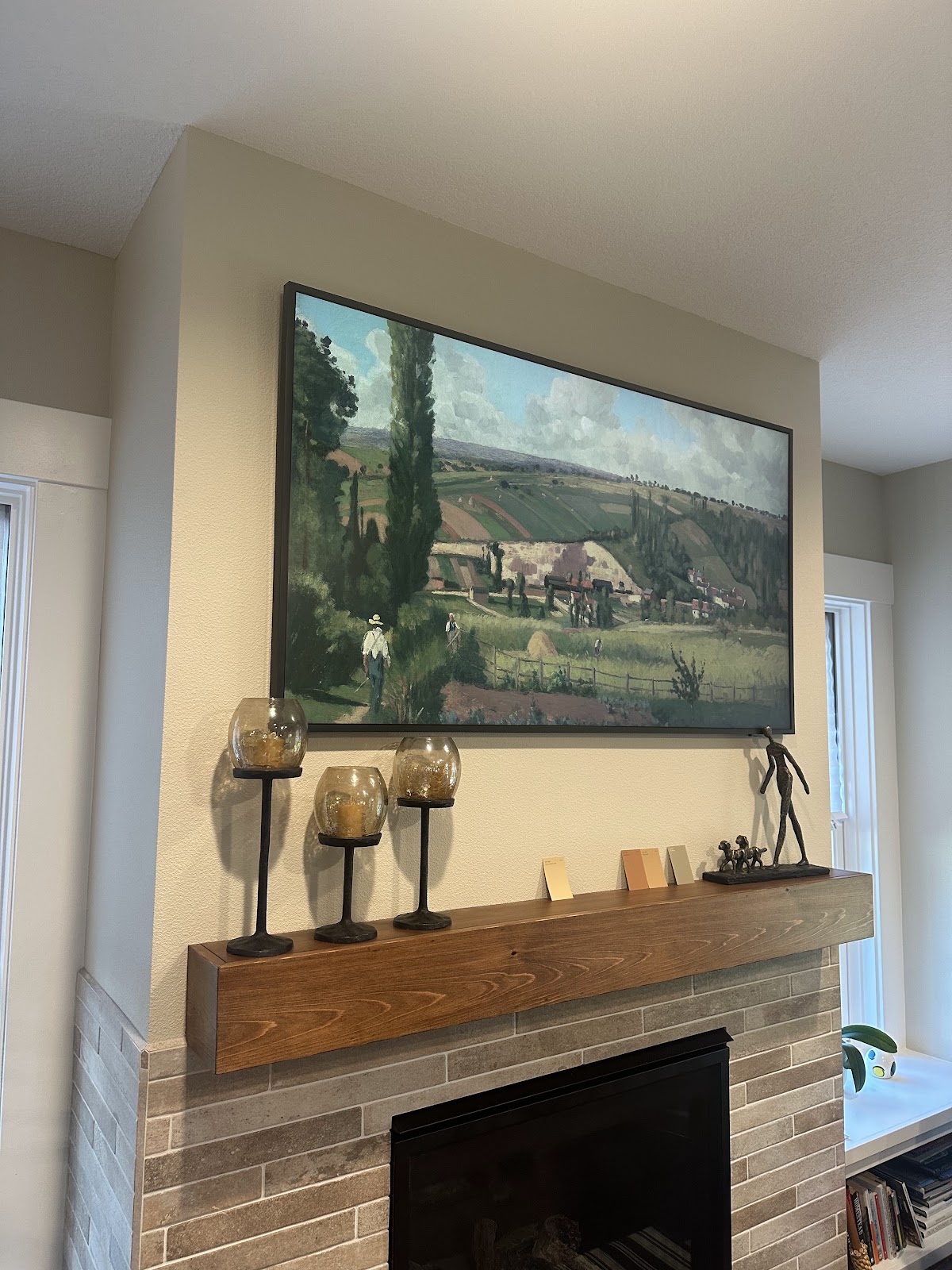 Remodeled fireplace and mantel near an updated kitchen space
