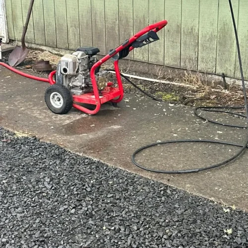 Exterior cleaning of a home driveway and siding using pressure matched to each surface