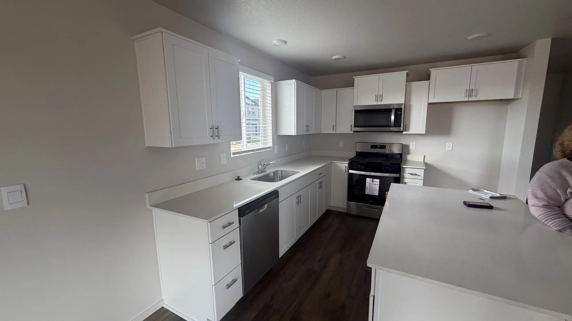 White kitchen remodel with updated cabinetry and clean finishes