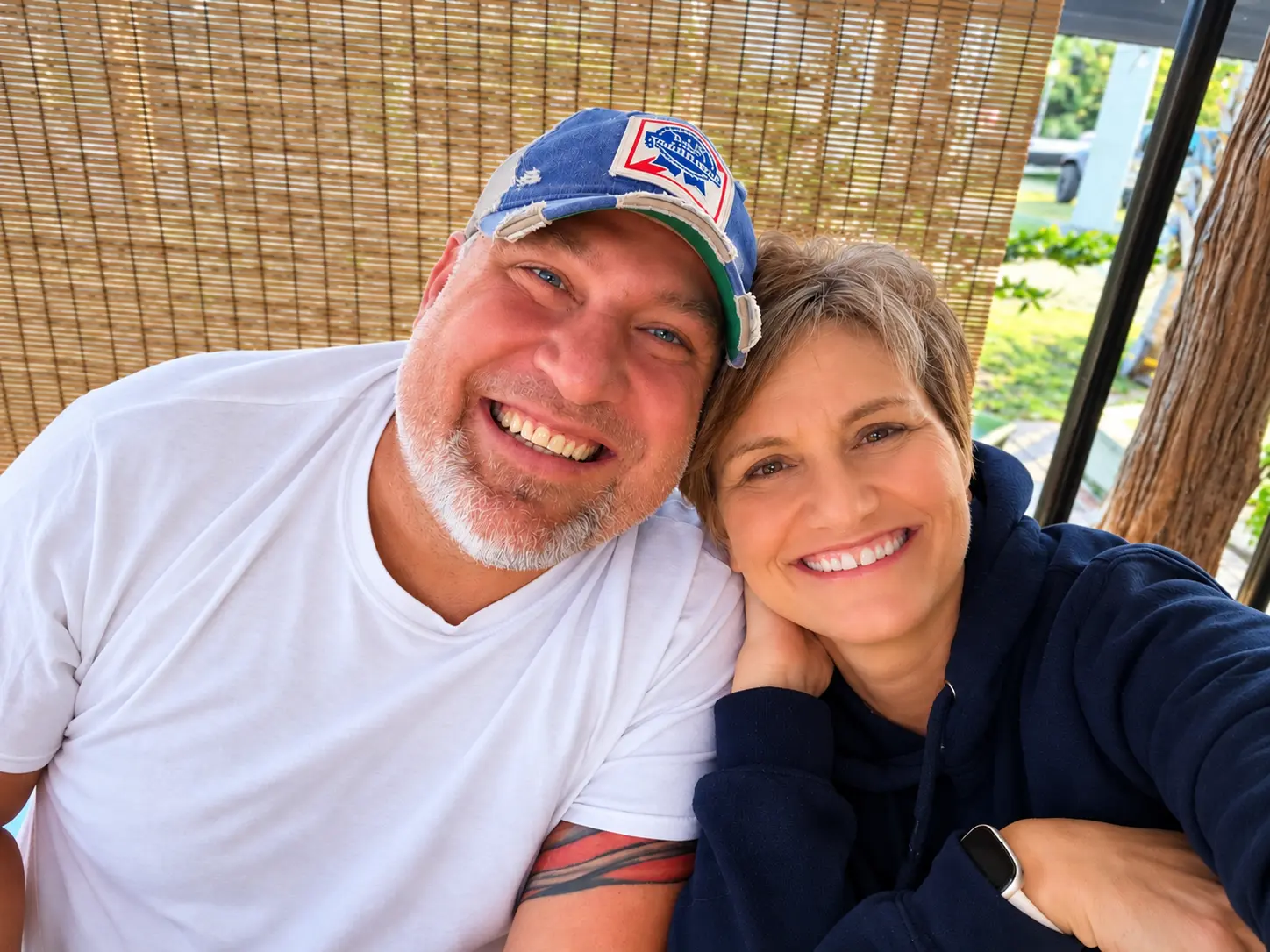 Dustin, owner of Happy Trails RV Transport, and his girlfriend Jeni smiling together.