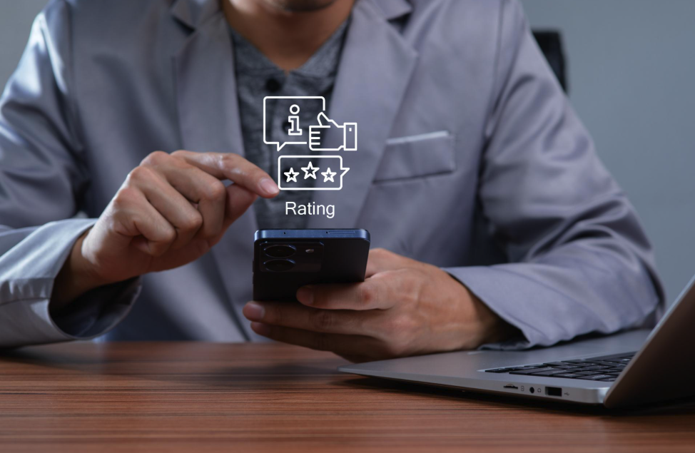 Business professional using a smartphone to manage online customer reviews and ratings as part of reputation management and local SEO strategy. Business professional using a smartphone to manage online customer reviews and ratings as part of reputation management and local SEO strategy.