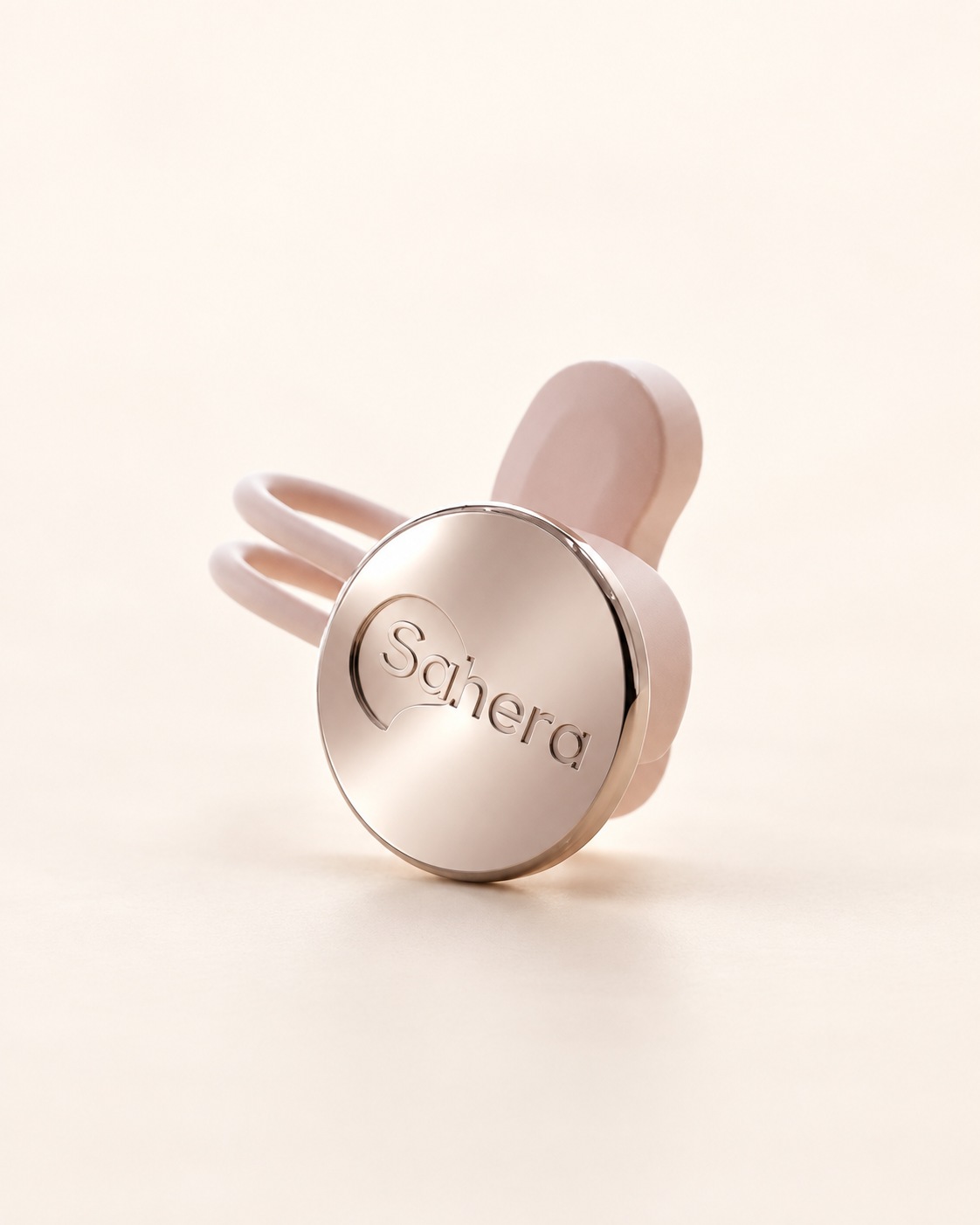Vue du dispositif seul : face chromée, fine liaison et partie arrière en silicone rose