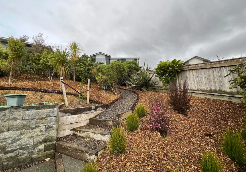 Fresh bark mulch spread across large garden area to retain moisture and reduce weeds