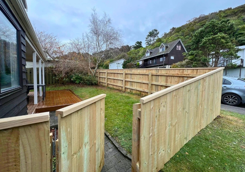 Newly built custom timber fence with matching gate showing top capping detail