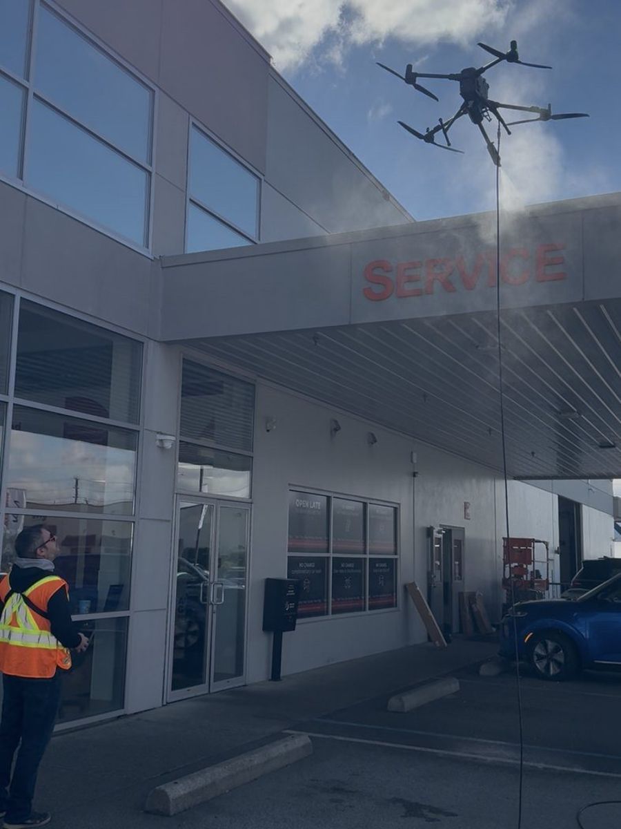 Drone cleaning a dealership service canopy