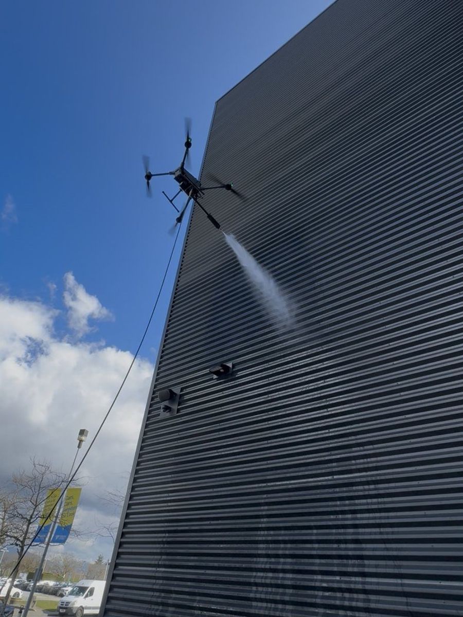 Drone soft-washing dark metal cladding