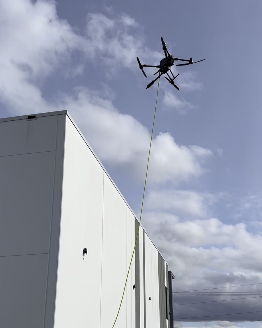 Tethered water line running from the ground to the drone