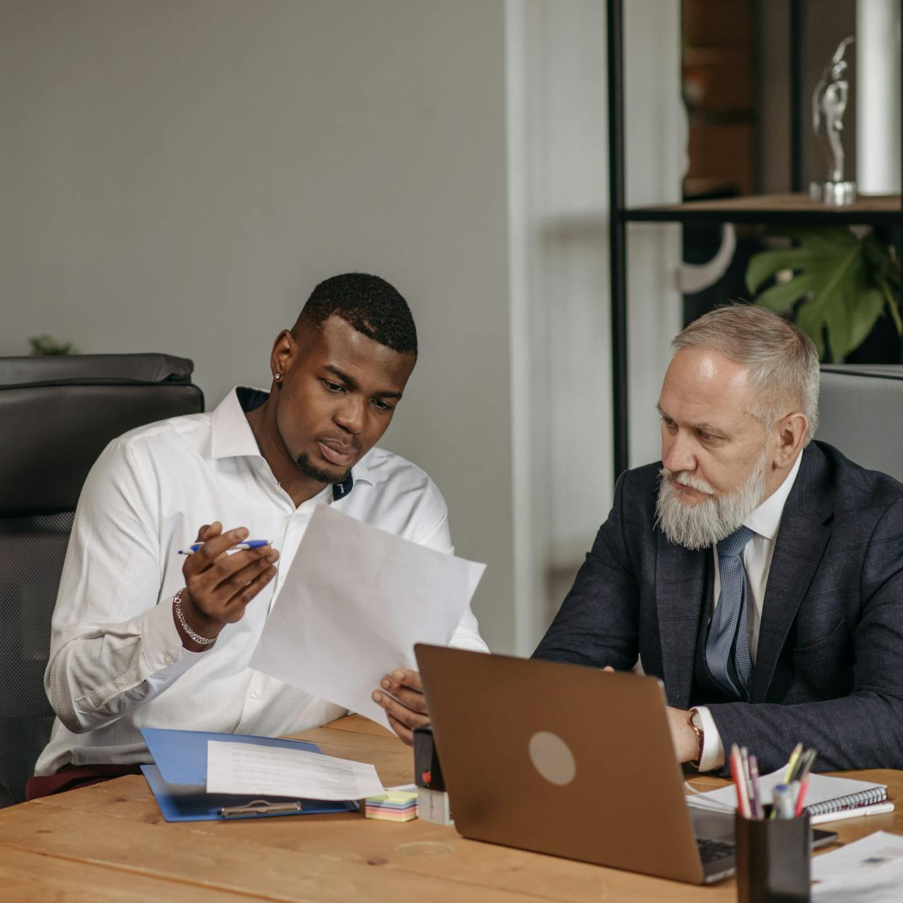 Business consultants reviewing strategy documents during a planning meeting