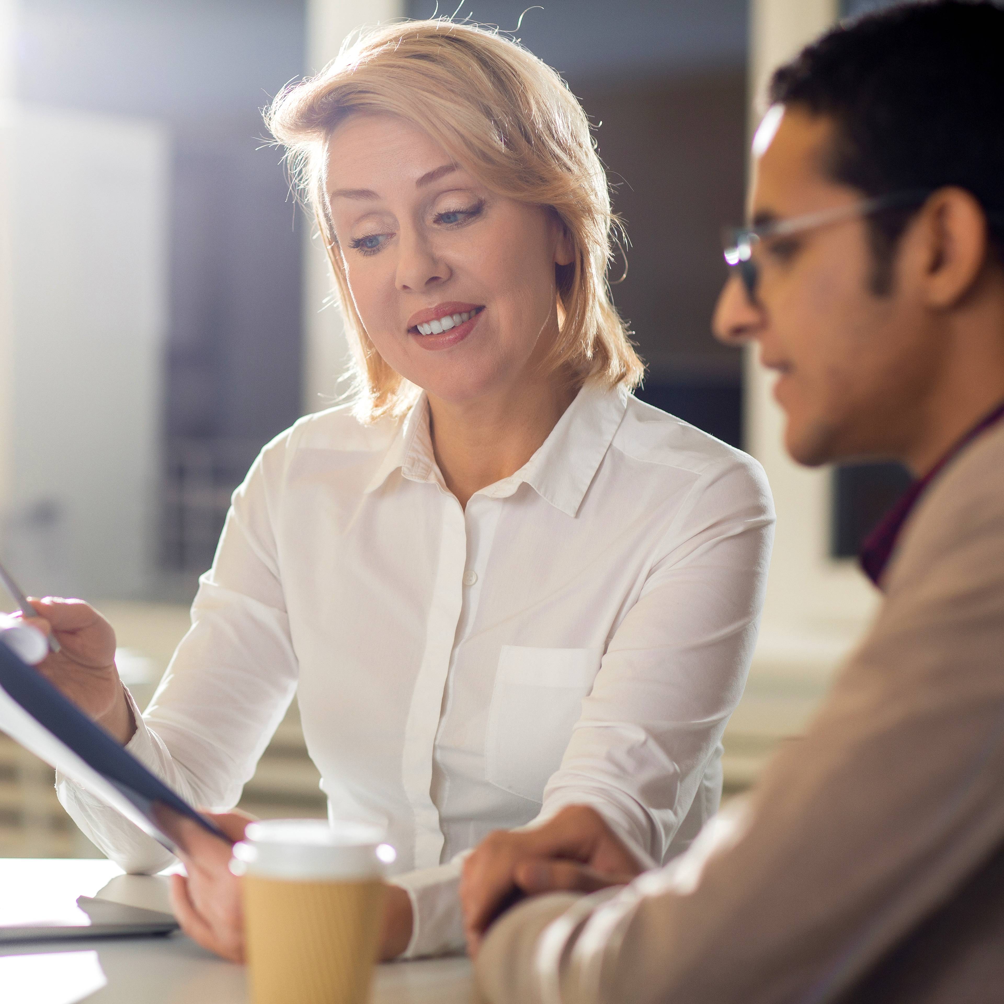 Business advisor guiding a client through strategic planning on a tablet