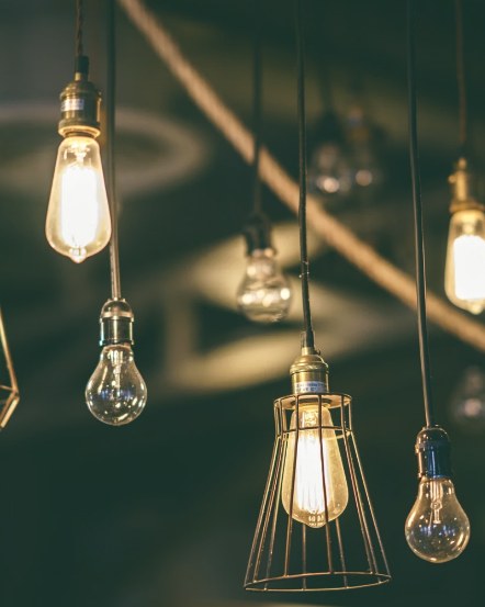 Warm Edison bulbs hanging in a dark room