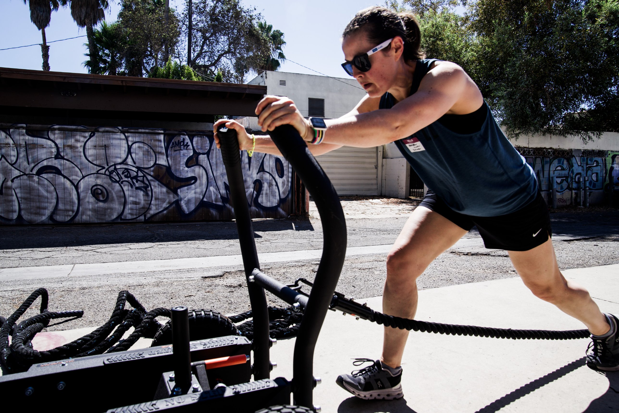 A member pushing a weighted sled outside The Phoenix Effect, a women and LGBTQ+ owned strength gym in Hollywood