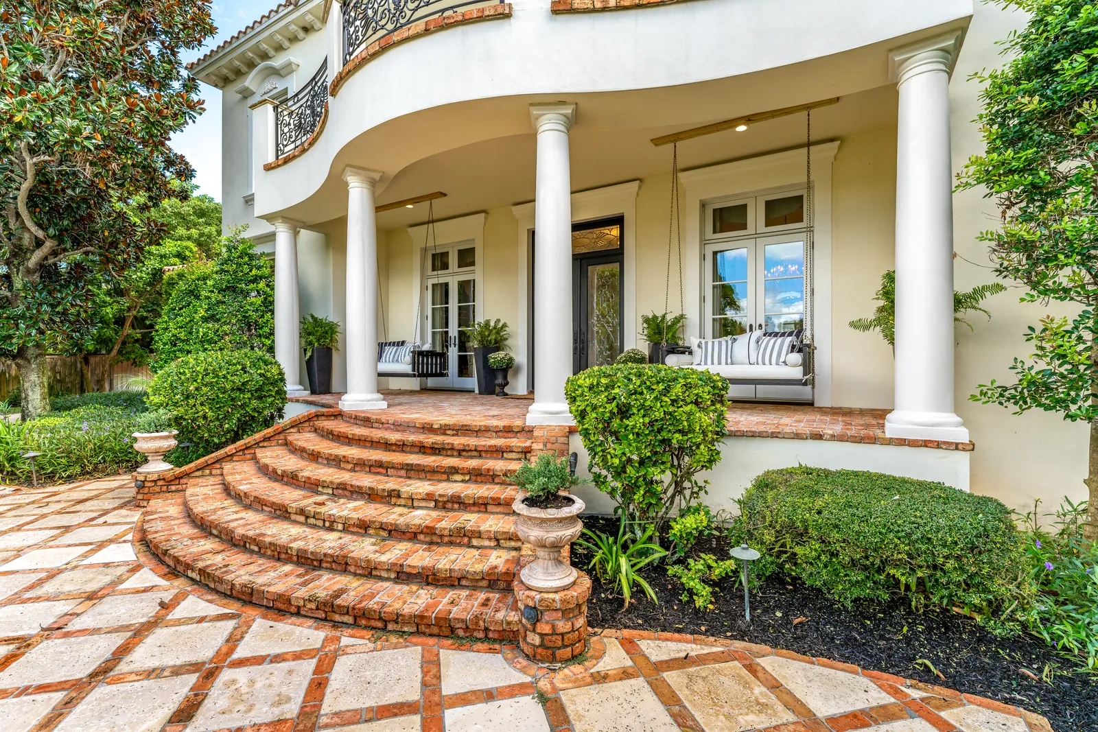 Welcoming porch with curved brick steps