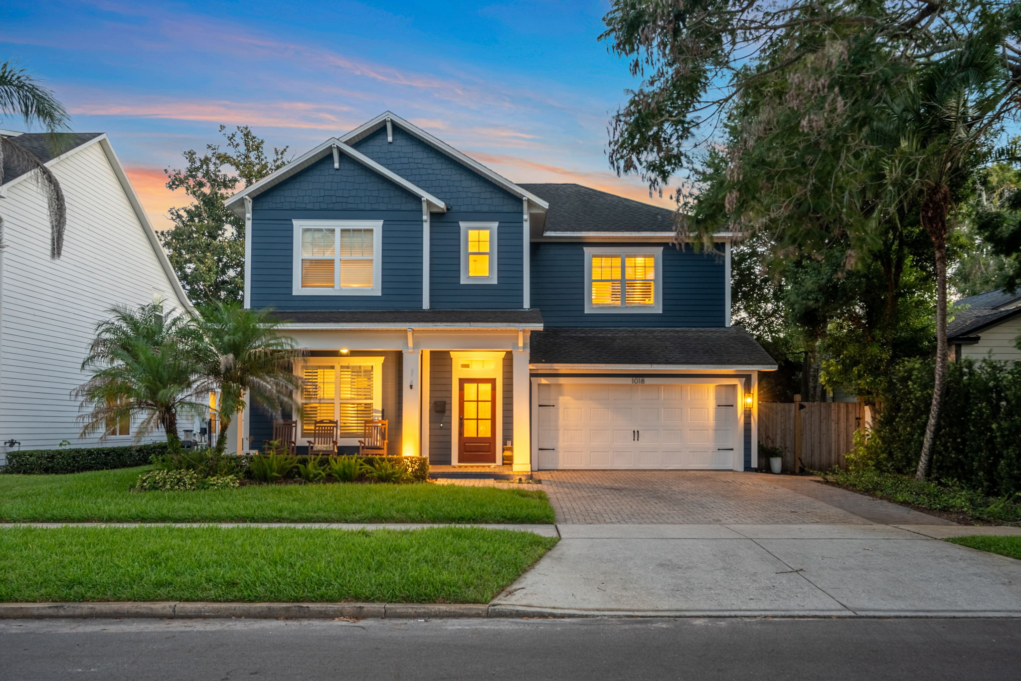 Twilight exterior with warm glowing windows