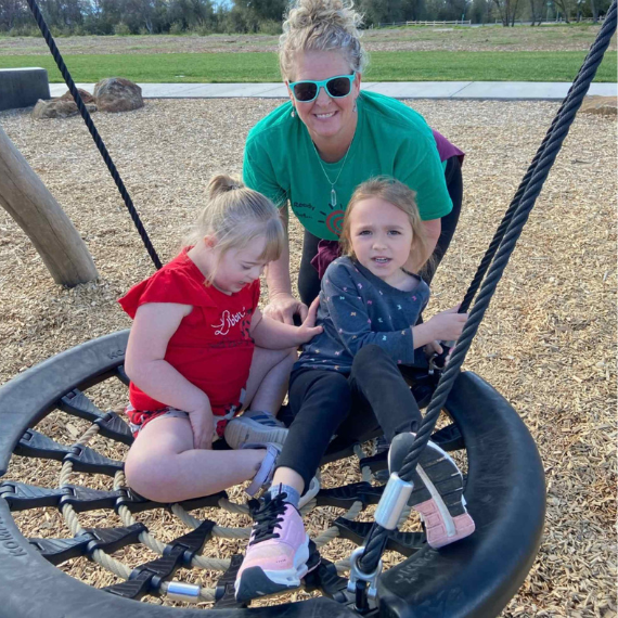Ready Set Goal therapist and children playing on a tire swing during an outdoor session