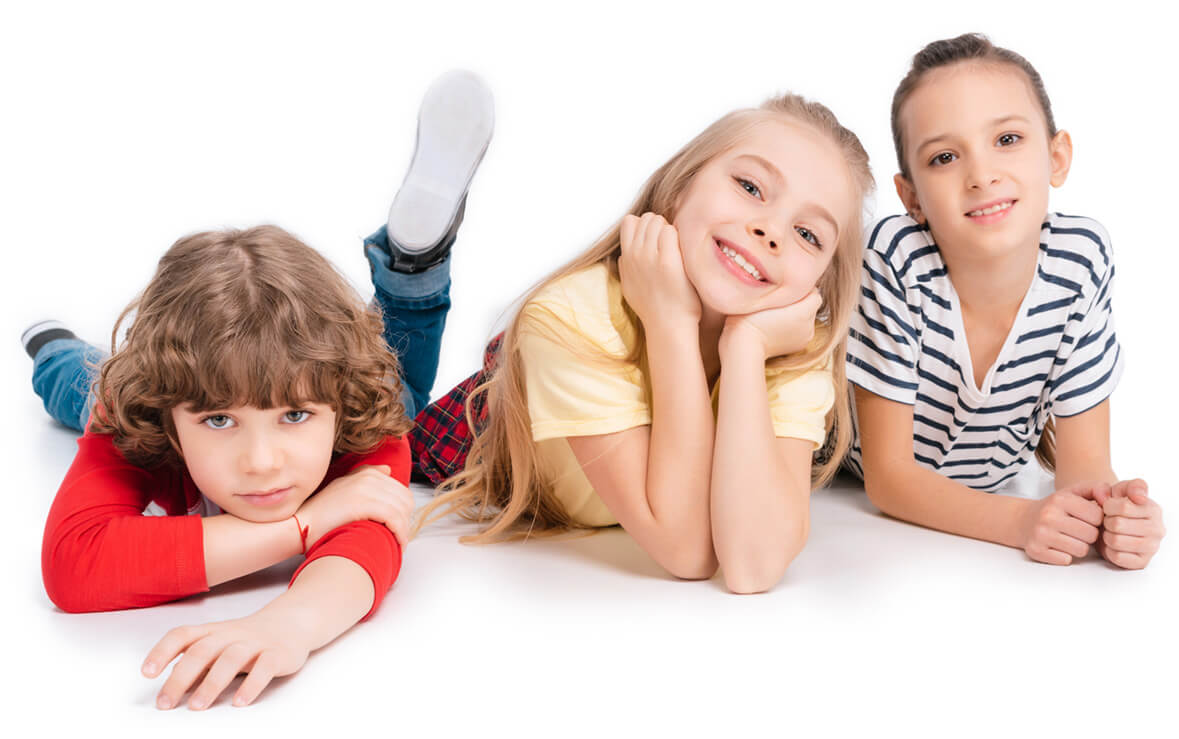 Three happy children lying on the floor and smiling together at Ready Set Goal