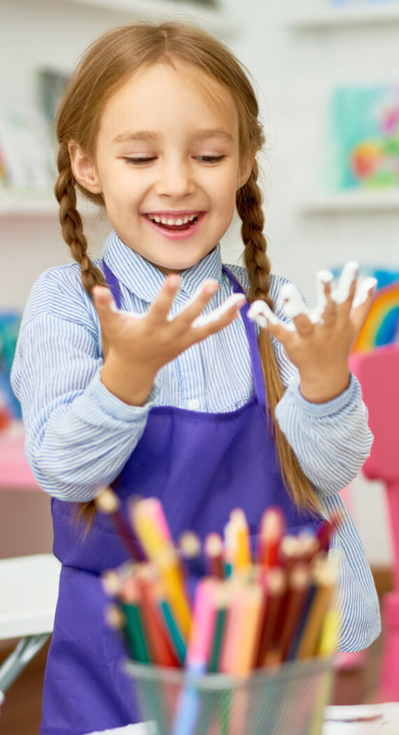 Children painting together in a personalized early intervention plan