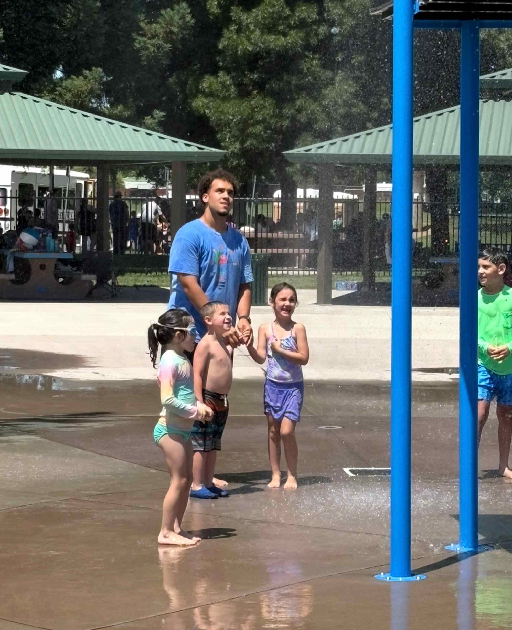 Children playing happily at a community water splash pad, building social connections