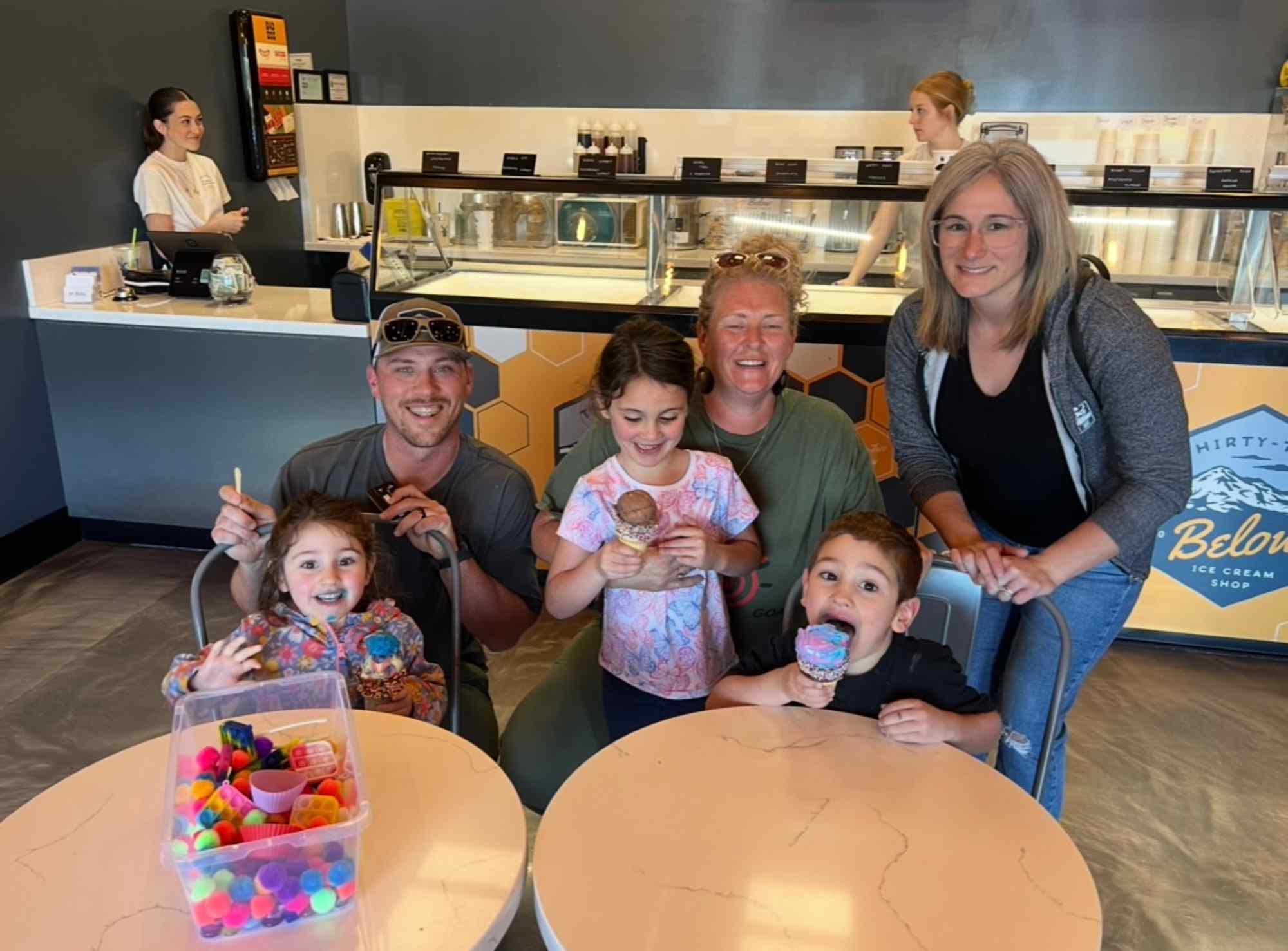 Happy family enjoying ice cream together, empowered by parent coaching