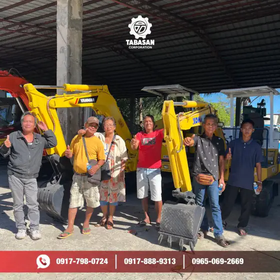 Buyers at the yard with their Yanmar and Komatsu backhoes