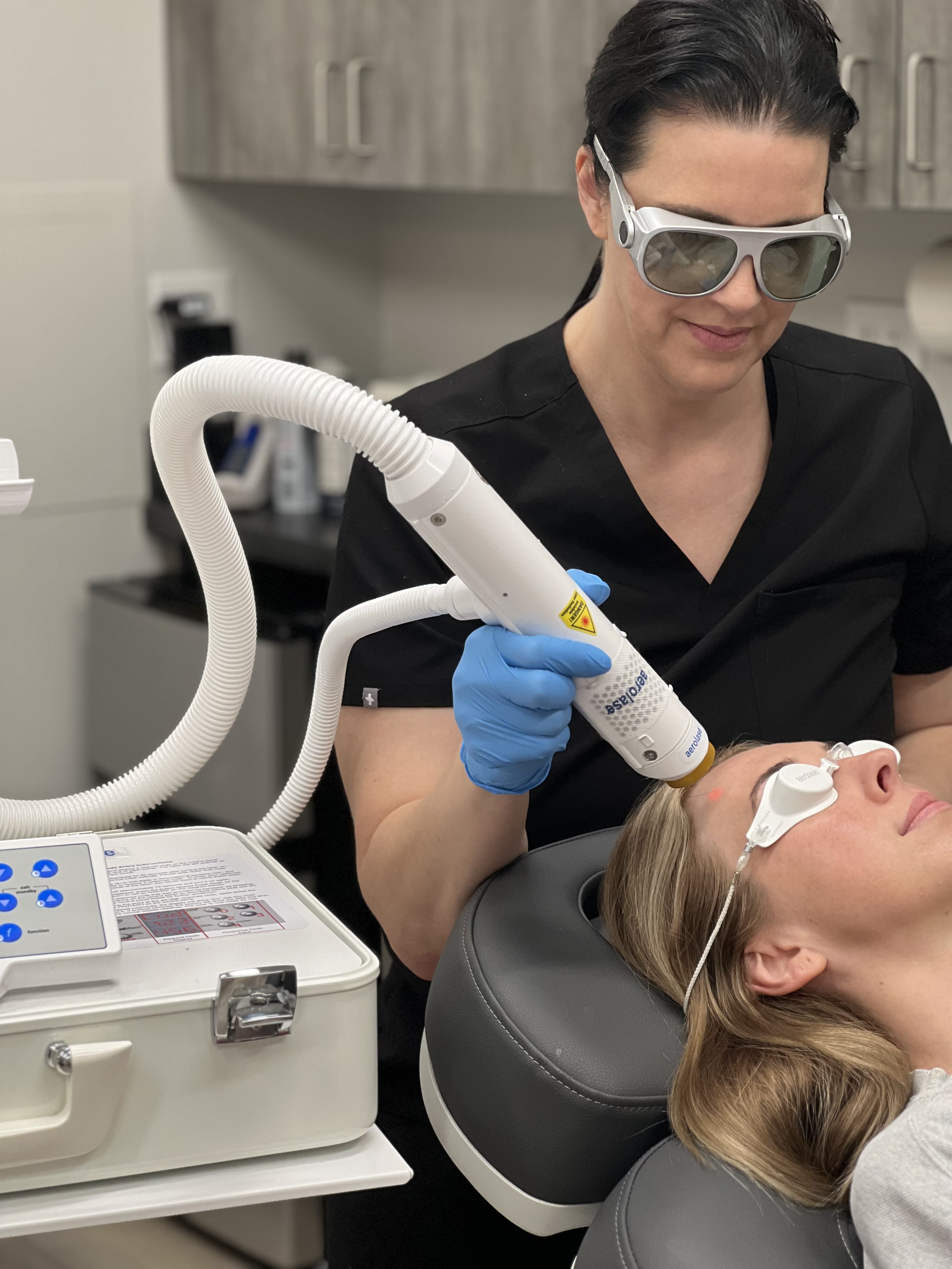 Sarah Crilly performing laser treatment