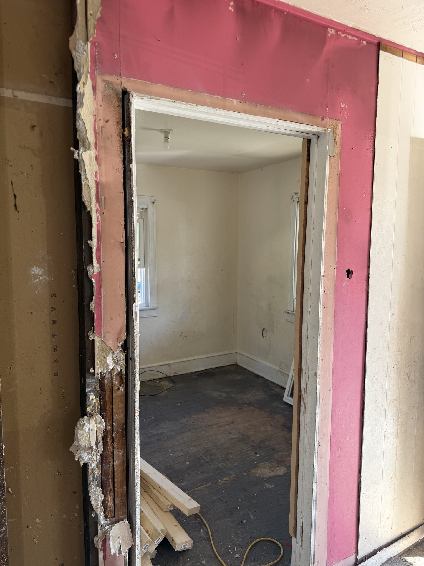 Bedroom doorway during interior tear-out