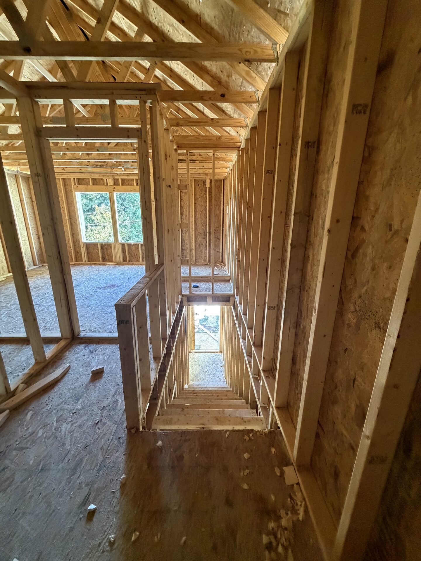 Looking down the framed stairwell from upstairs