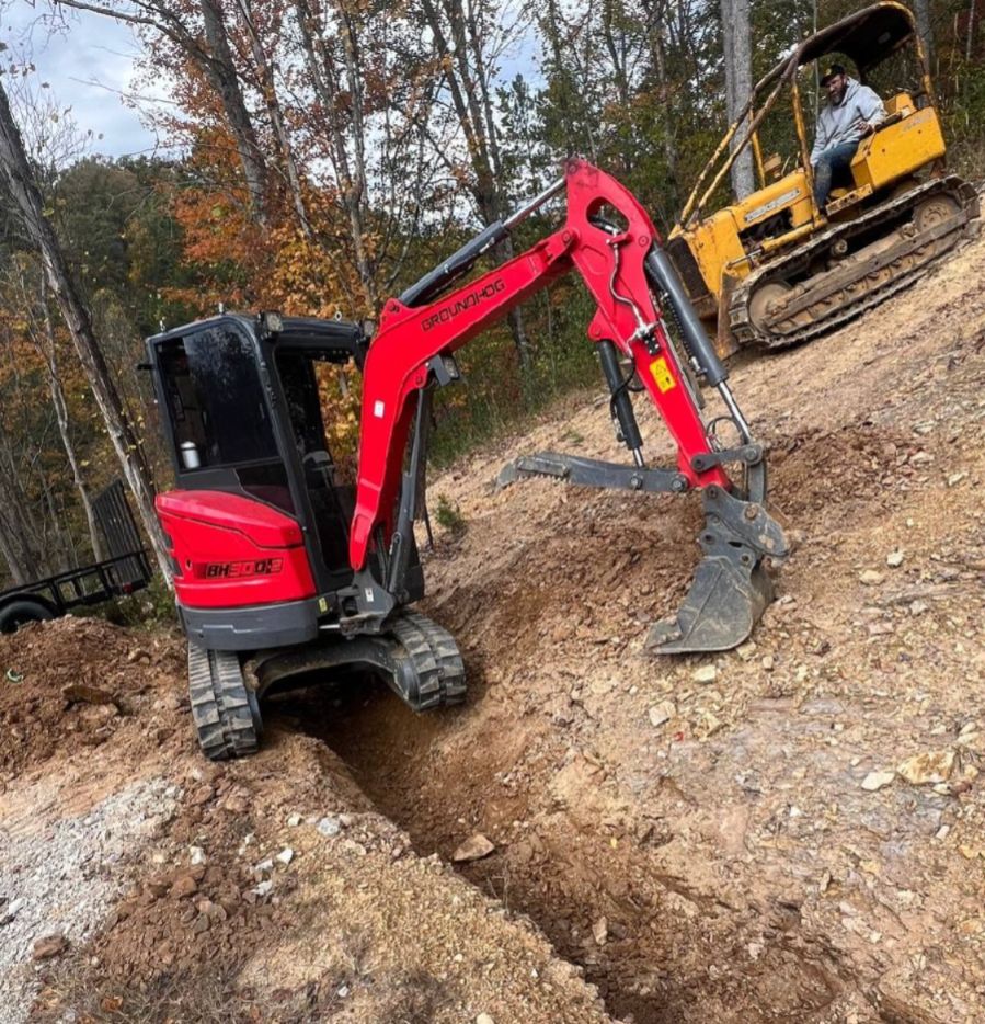 Mini excavator and dozer performing excavation and grading work in Huntington WV