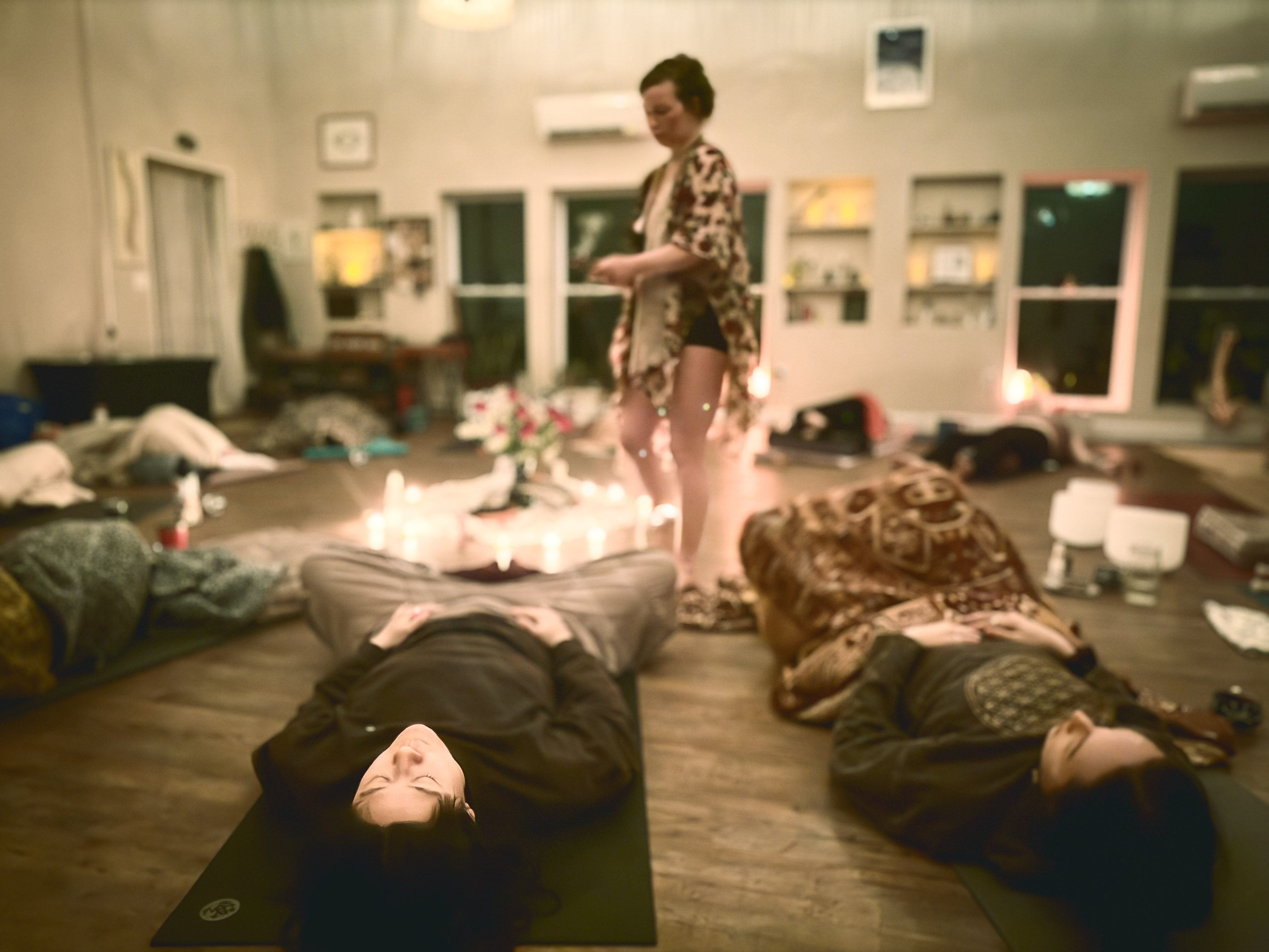Small group resting on mats during a guided wellness afternoon