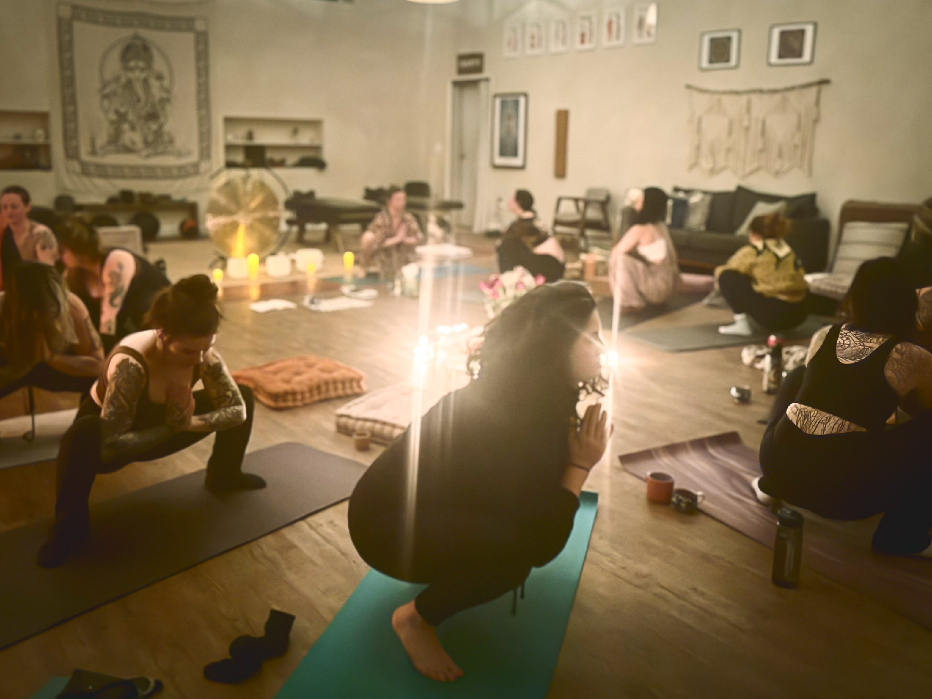 Participant resting during a candlelit sound healing session