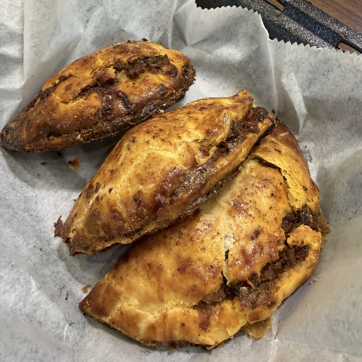 Golden baked meat pies stuffed with seasoned beef at Pee Wee's Soul Food, Rock Island IL