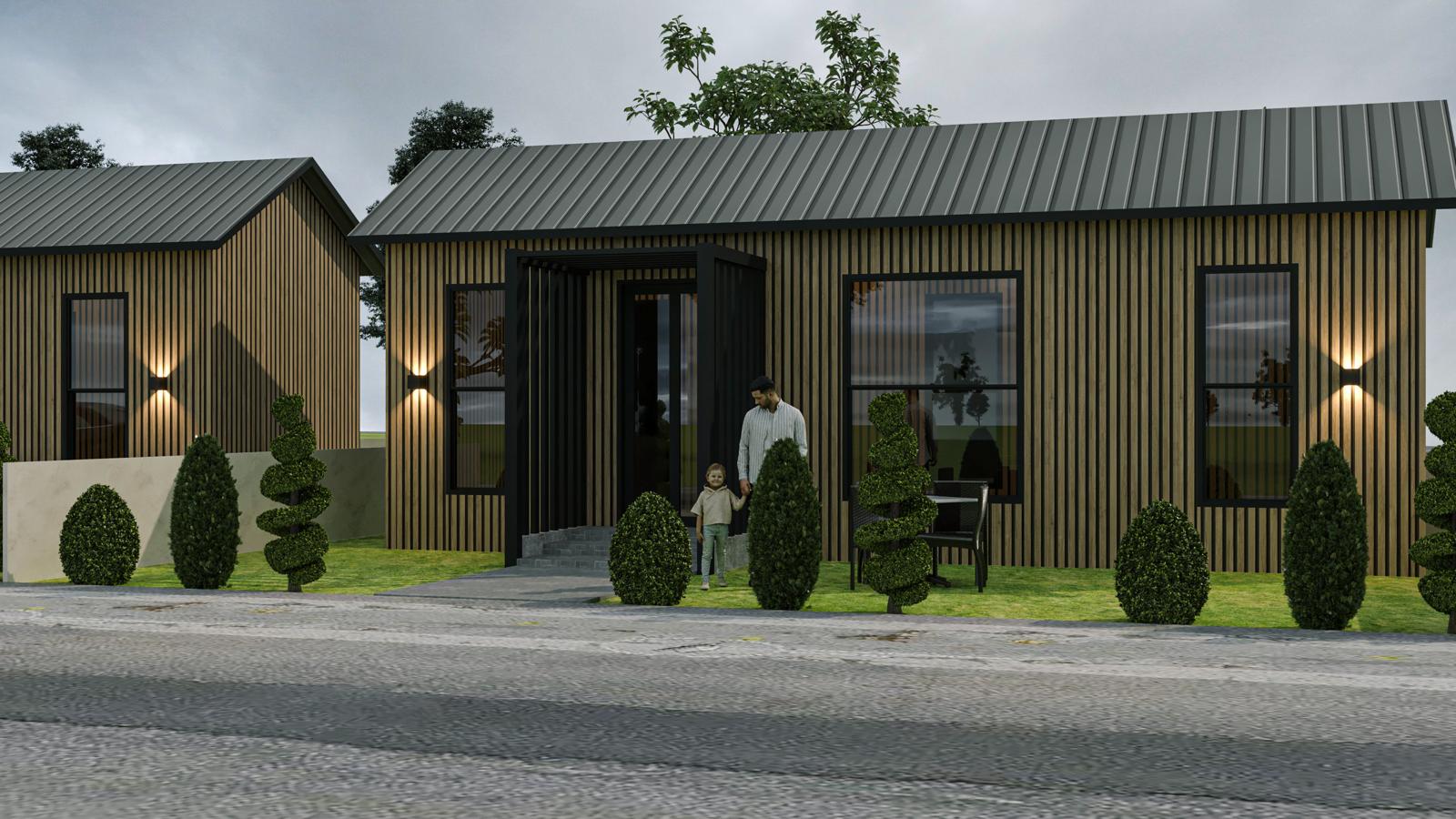 A couple at the warmly lit entrance of a tiny home in the evening