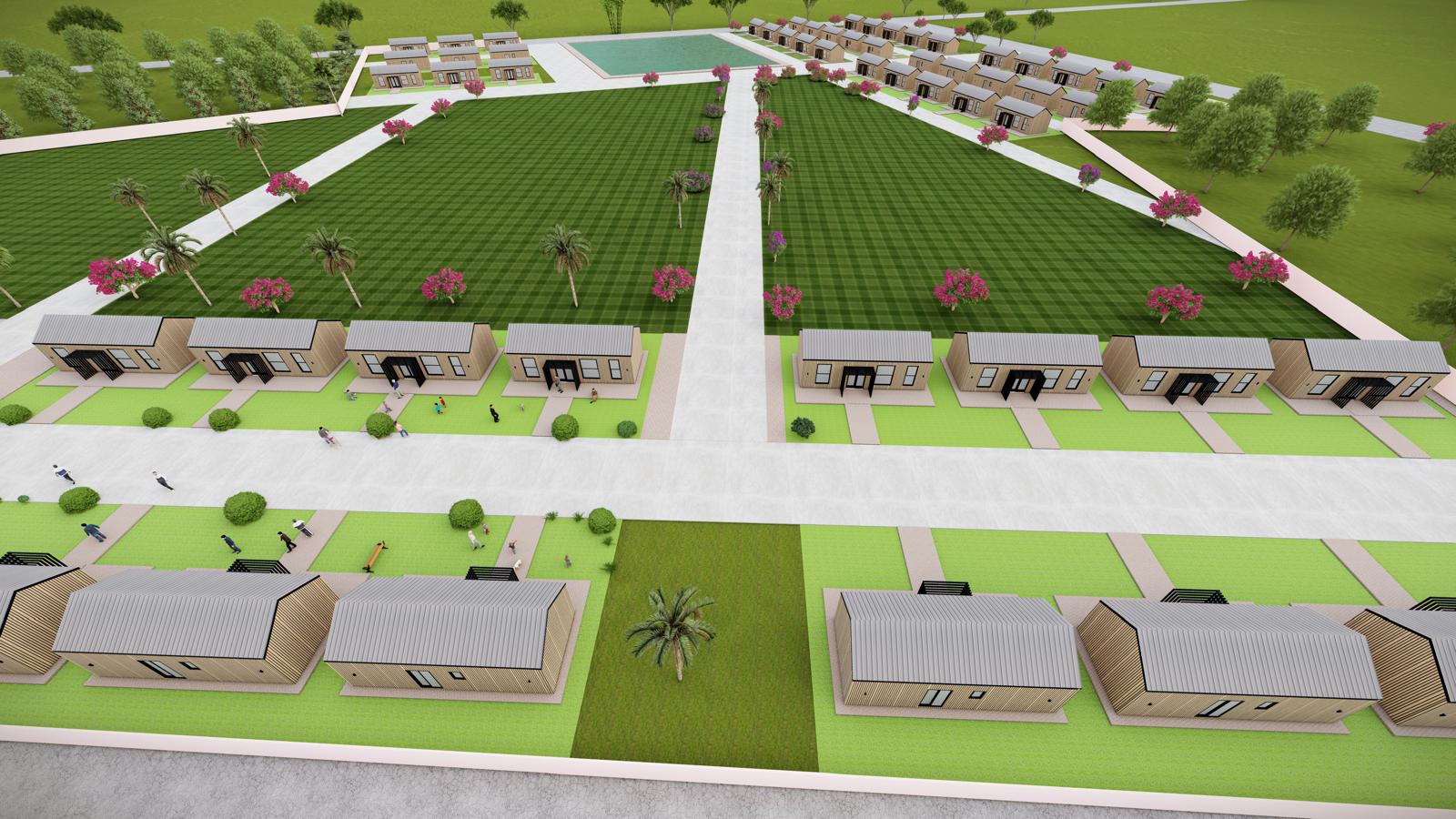 Aerial view of the full tiny home development with green lawns
