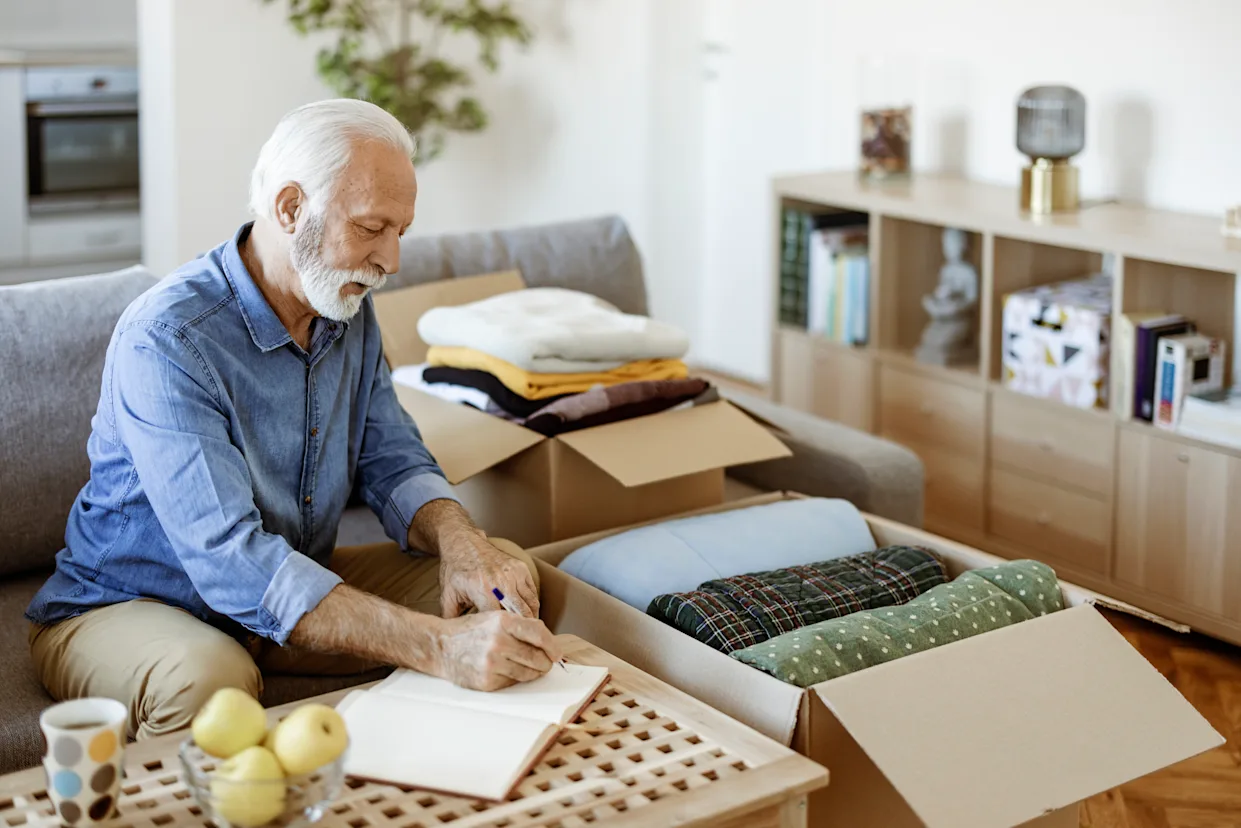 homeowner sorting belongings while deciding what to keep during downsizing