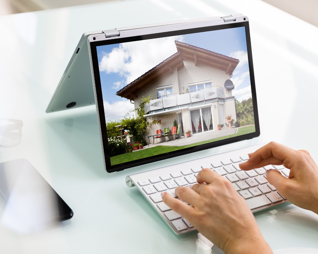 photo of a laptop that shows a picture of a house