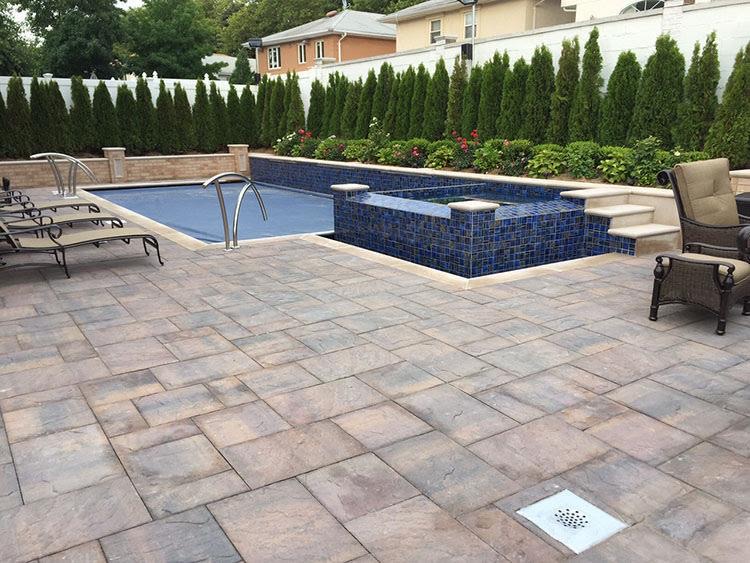 Stone paver patio installed beside a residential pool