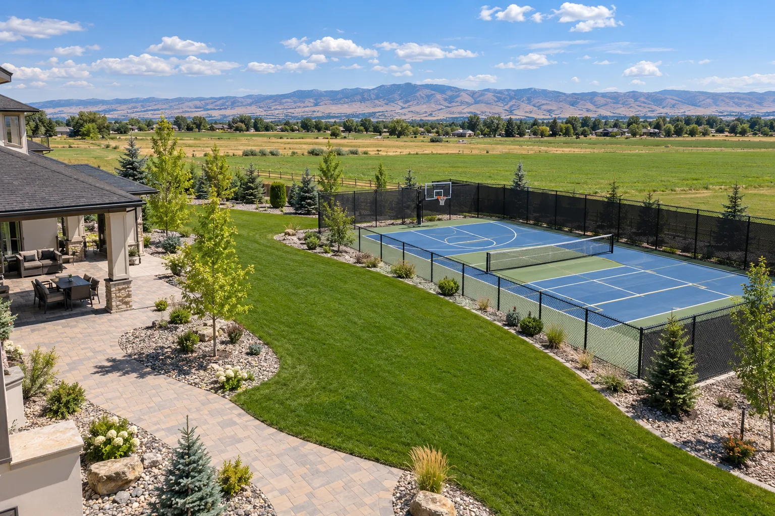 Wide view of a fenced multi-use pickleball and basketball sport court on a large lot in Star, Idaho