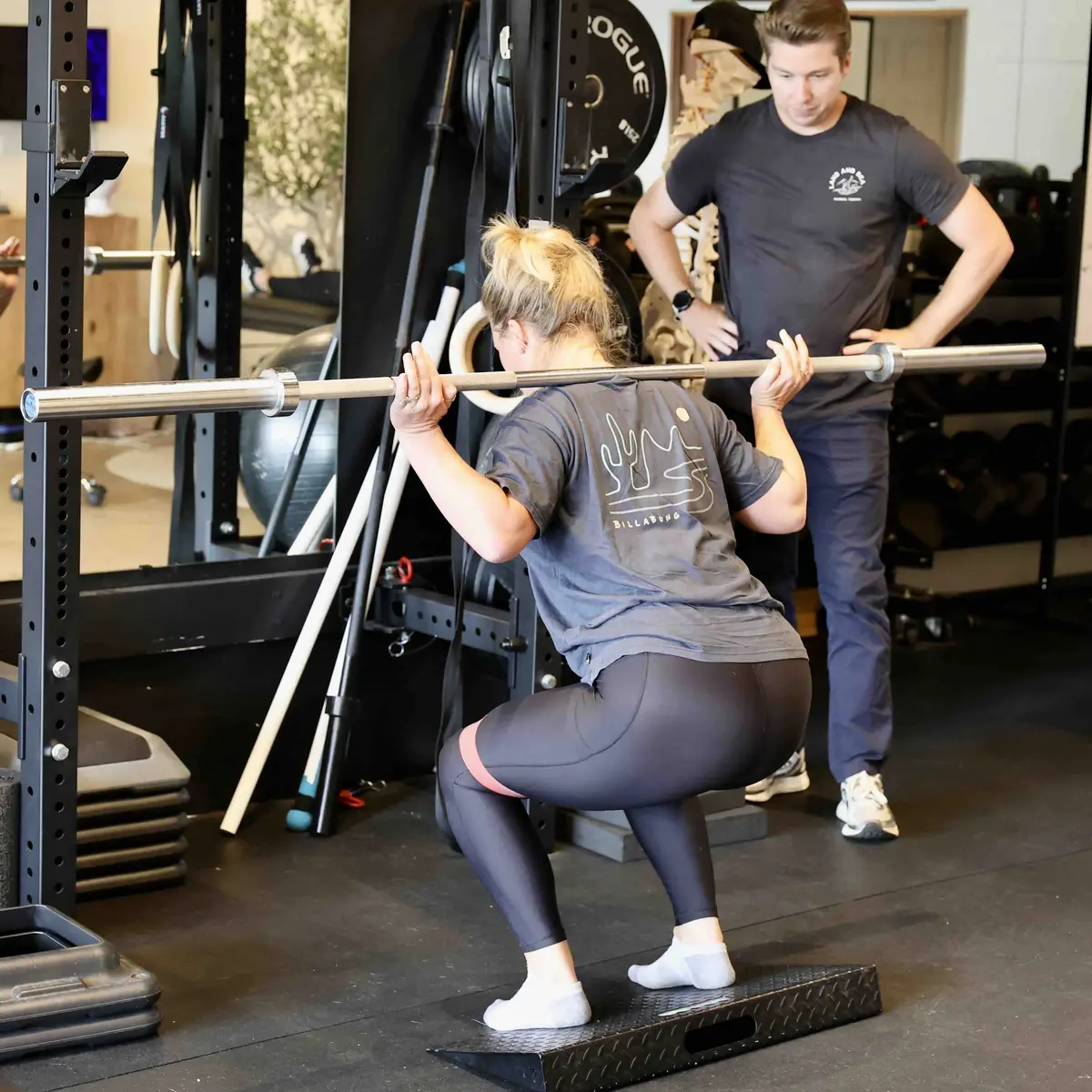 Coaching a barbell squat at Land and Sea PT