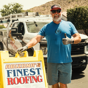 A friendly Chandler roofing contractor from Arizona’s Finest Roofing giving a thumbs up in front of a service truck.
