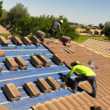 Arizona’s Finest Roofing crew installing concrete tiles over blue synthetic underlayment in a newer Queen Creek neighborhood.