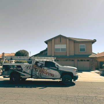 A service vehicle from the best local roofing company in Scottsdale parked at a job site, offering services from the top roofing companies in Arizona.