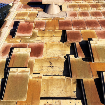Close-up of cracked and slipped concrete tiles being prepared for San Tan Valley roof repair to restore the home's protective barrier.