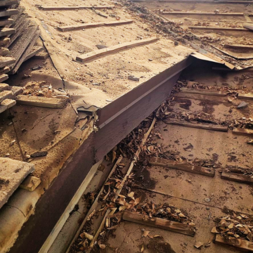 Detailed view of damaged underlayment and debris during a roof inspection tempe az.